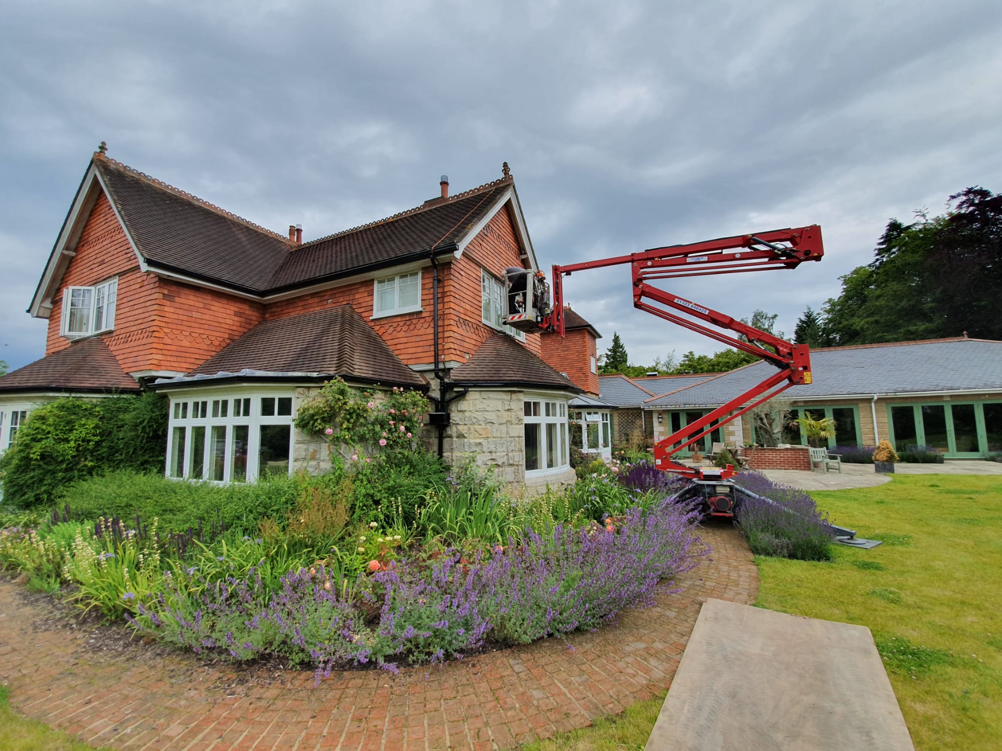 Specialist access platform at a large property with a curved path and lavender borders